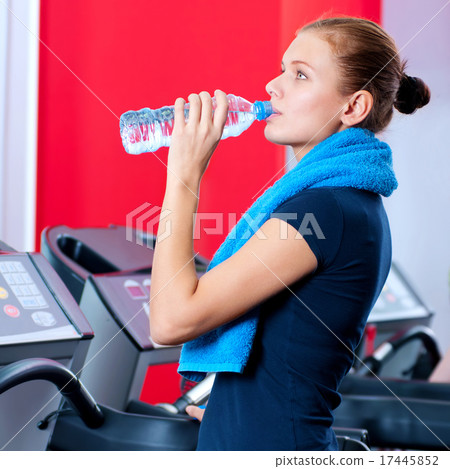 Woman at the gym drinking water Woman at the gym drinking water 17445852