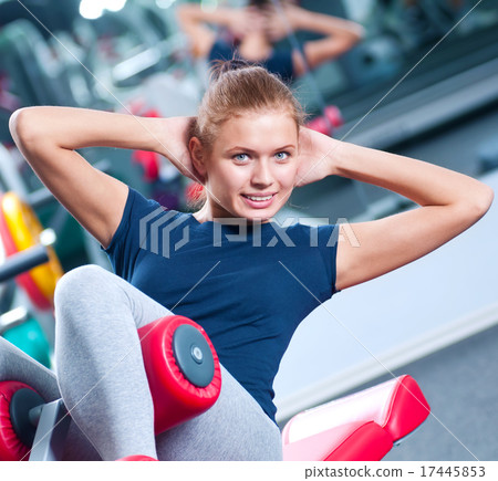 Woman at the gym exercising Woman at the gym exercising 17445853