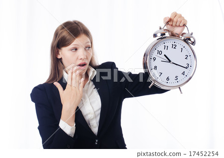 Businesswoman with clock isolated on white 17452254