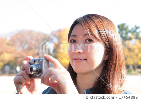 A landscape young lady with a digital camera 17454889
