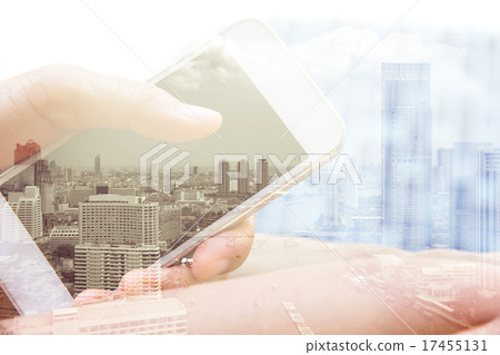 Double exposure of hand with mobile phone  17455131