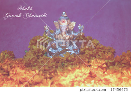Ganesh idol with sunflower and oil lamp Ganesh idol with sunflower and oil lamp 17456473