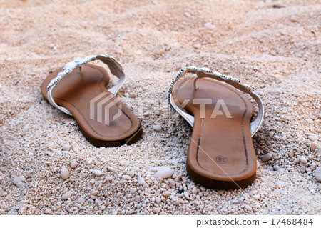 Nice ladies sandals on the sandy beach Nice ladies sandals on the sandy beach 17468484