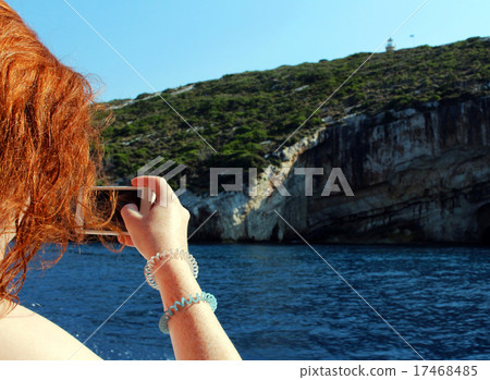 Girl makes photo with mobile phone on the holiday Girl makes photo with mobile phone on the holiday 17468485