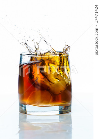 Glass of scotch whiskey and ice white background 17471424