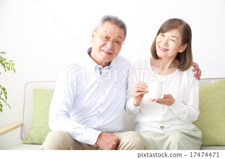Senior couple with good friends at tea time Senior couple with good friends at tea time 17474471