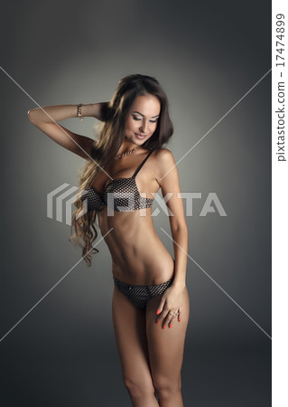 Smiling tanned woman posing in polka dot underwear 17474899