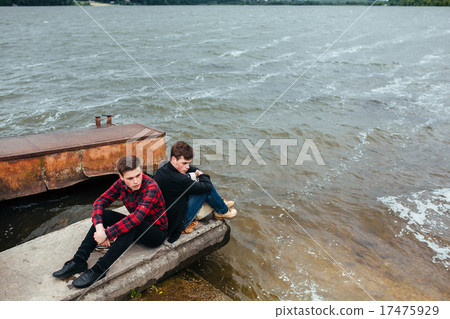 Two friends relaxing on the pier. Two friends relaxing on the pier. 17475929