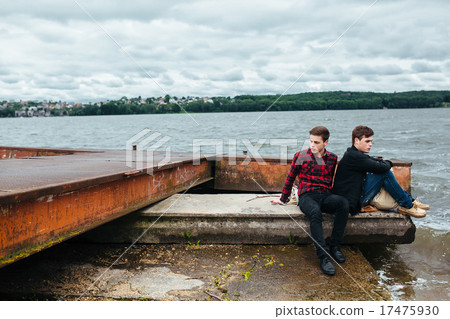 Two friends relaxing on the pier. Two friends relaxing on the pier. 17475930
