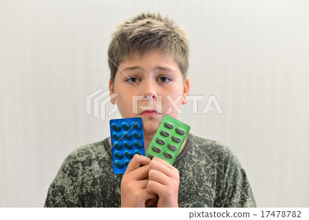 Boy in camouflage shirt holding a drugs Boy in camouflage shirt holding a drugs 17478782