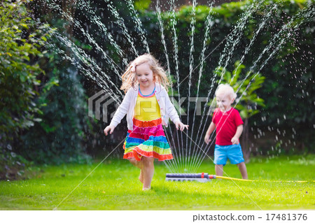 Kids playing with garden sprinkler Kids playing with garden sprinkler 17481376
