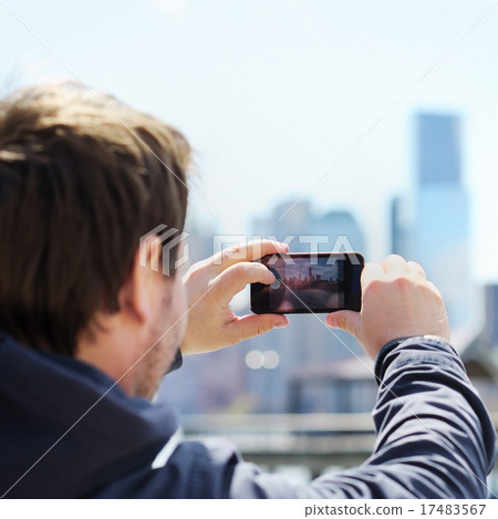 Tourist taking mobile photo of skyscrapers Tourist taking mobile photo of skyscrapers 17483567