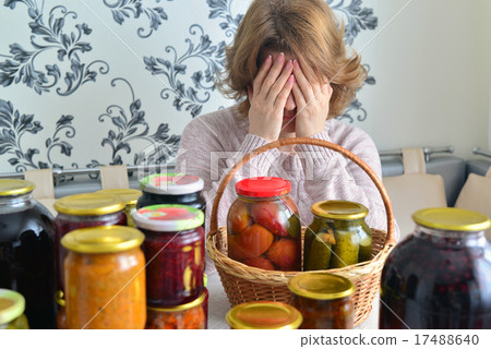 Tired woman sitting near home canning for  winter 17488640