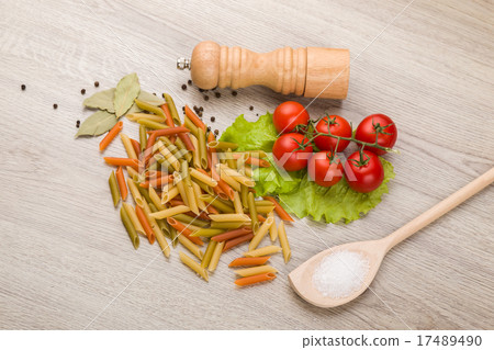 Pasta, tomatoes and pepper on a wooden background 17489490