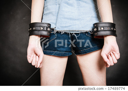 Arrest. Leather handcuffs on hands prisoner girl Arrest. Leather handcuffs on hands prisoner girl 17489774