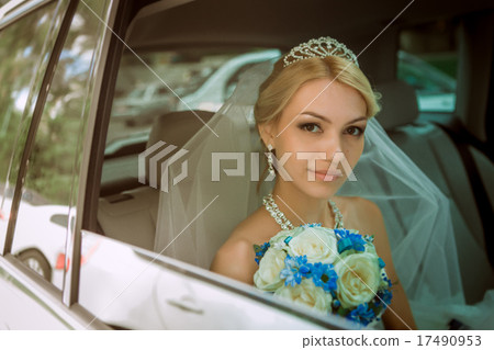 close-up portrait of a pretty shy bride in a car  17490953