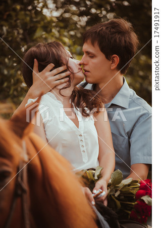 Young beautiful couple with a horse. Filtered. Young beautiful couple with a horse. Filtered. 17491917