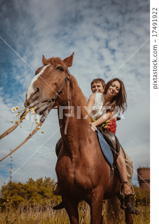 Young beautiful couple with a horse. Filtered. Young beautiful couple with a horse. Filtered. 17491922