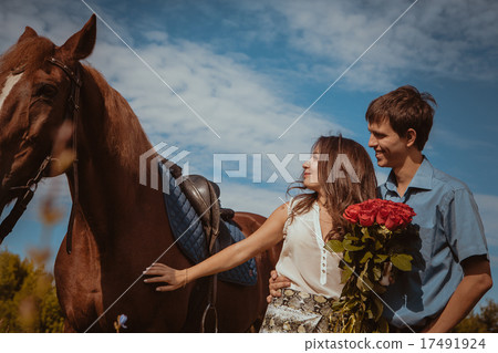 Young beautiful couple with a horse. Filtered. Young beautiful couple with a horse. Filtered. 17491924