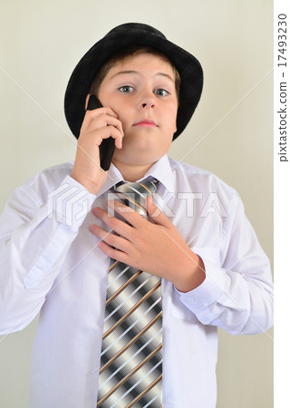 Teen boy talking on cell phone at  light 17493230