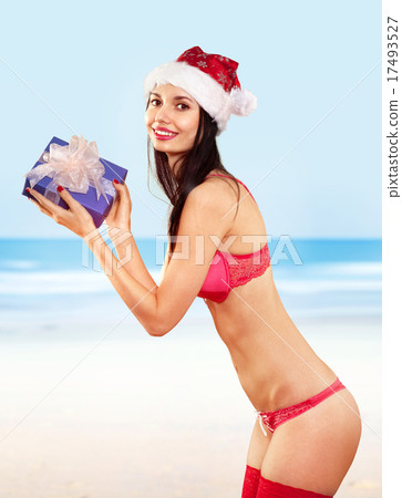 mrs claus with gift on beach mrs claus with gift on beach 17493527
