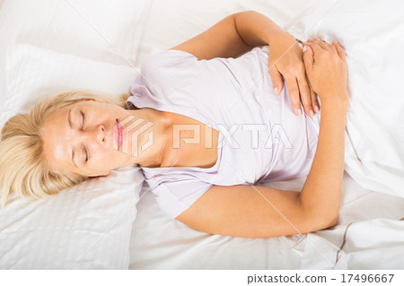Middle-aged woman sleeping in bed Middle-aged woman sleeping in bed 17496667
