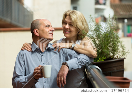 Aged couple drink tea on balcony Aged couple drink tea on balcony 17496724