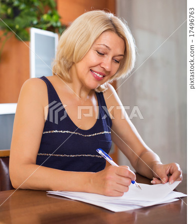 Mature woman with financial documents 17496763