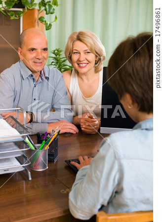 elderly couple of pensioners talking with employee elderly couple of pensioners talking with employee 17496861