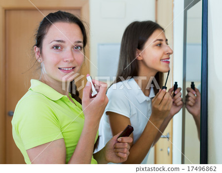Teenage girlfriends having fun near mirror Teenage girlfriends having fun near mirror 17496862