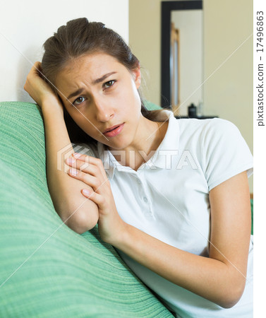 Upset girl on sofa at home Upset girl on sofa at home 17496863