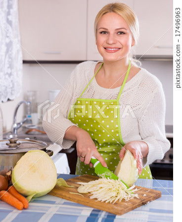 Blonde in apron chopping cabbage Blonde in apron chopping cabbage 17496963