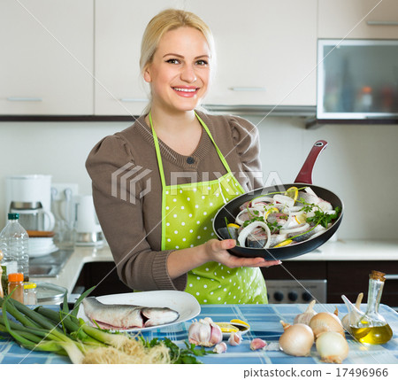 Housewife cooking fish at home Housewife cooking fish at home 17496966