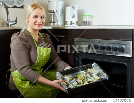 Joyful woman cooking fish 17497008