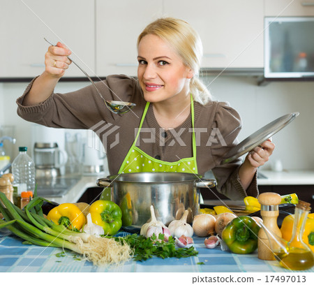 Woman in apron at home kitchen 17497013