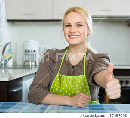 Woman in apron with thumbs up Woman in apron with thumbs up 17497068