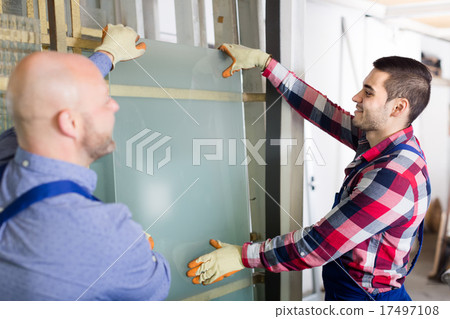 Two smiling workmen at factory 17497108