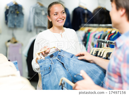 Couple buying blue jeans at store . 17497156