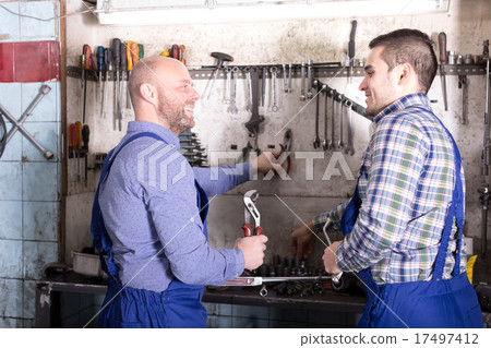 Positive servicemen in a workshop 17497412