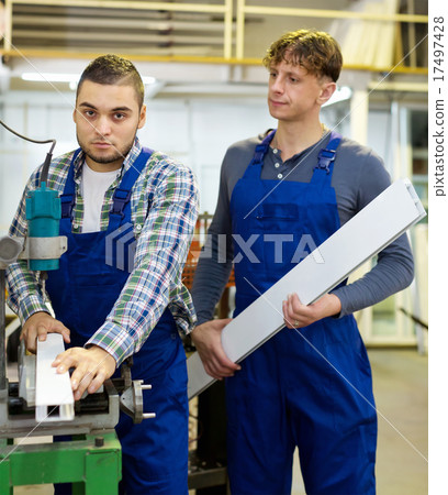 Workers cutting window profiles 17497428