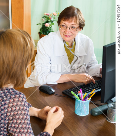 mature doctor advises a woman mature doctor advises a woman 17497554