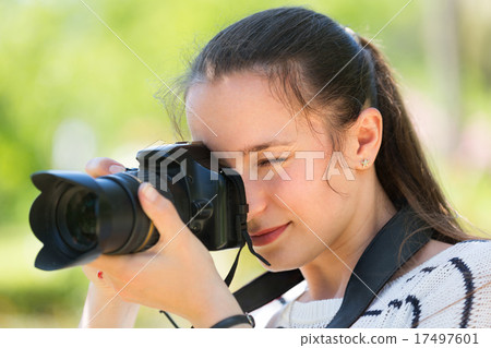 Girl with photocamera at park 17497601