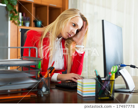Tired girl in office 17497778