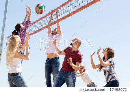 People play volleyball on beach 17498072