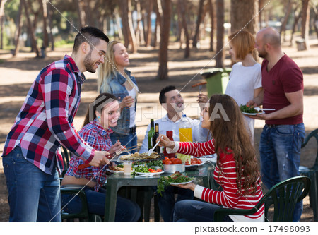 Young friends relaxing at grill 17498093