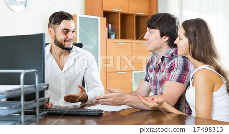 Couple and manager talking about purchase in the office Couple and manager talking about purchase in the office 17498313