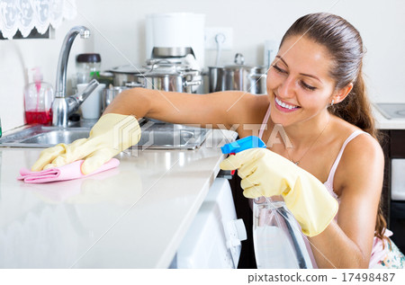 girl polishing shelves indoors 17498487