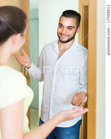 Woman meeting man at the door 17498611