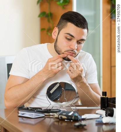Guy popping a pimple 17498709