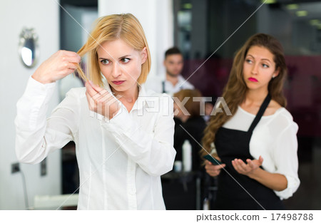 Displeased client and hairdresser. 17498788